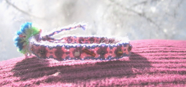 Unique friendship bracelets bespangled with colored beads, accessorized with colored fuzz and switchable knot